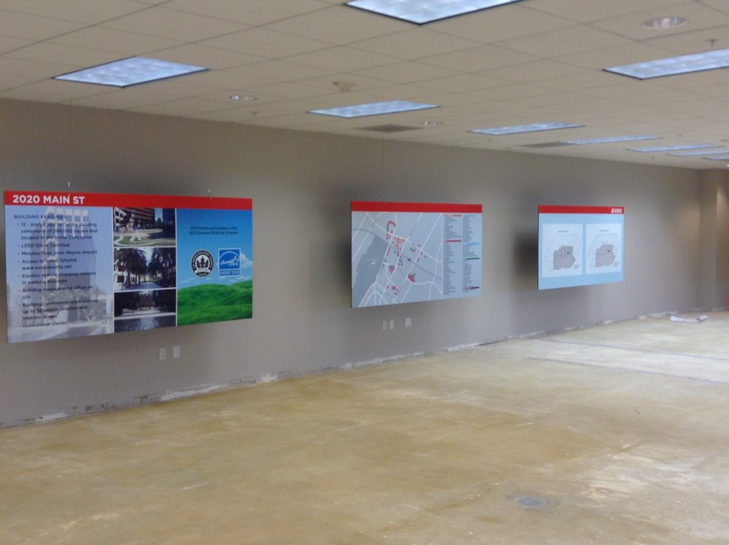 Several informational boards printed on Gator board and hung inside of an empty building for lease.