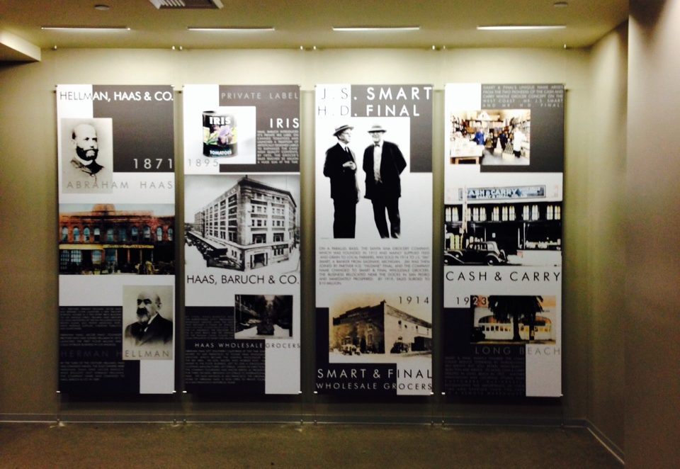 Four boards hung up in a company's lobby which depict milestones from the company's history.